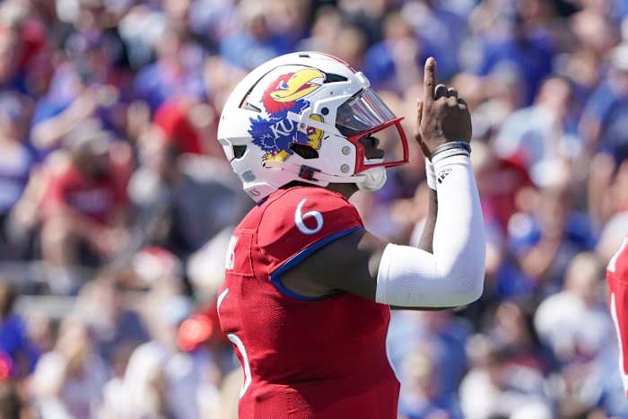 Kansas QB Jalon Daniels points to the sky in celebration.